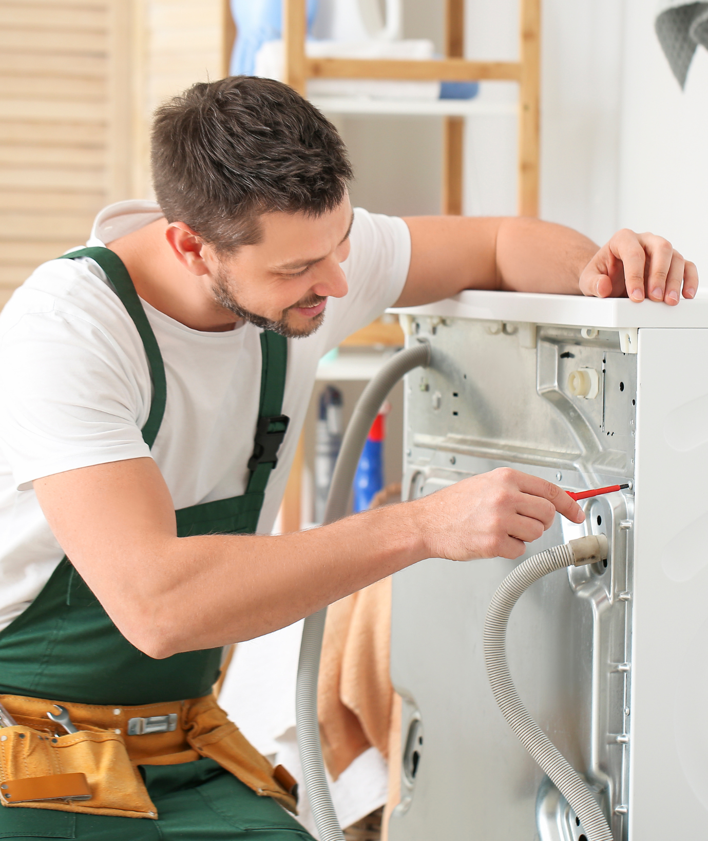 Technician repairing a washing machine
