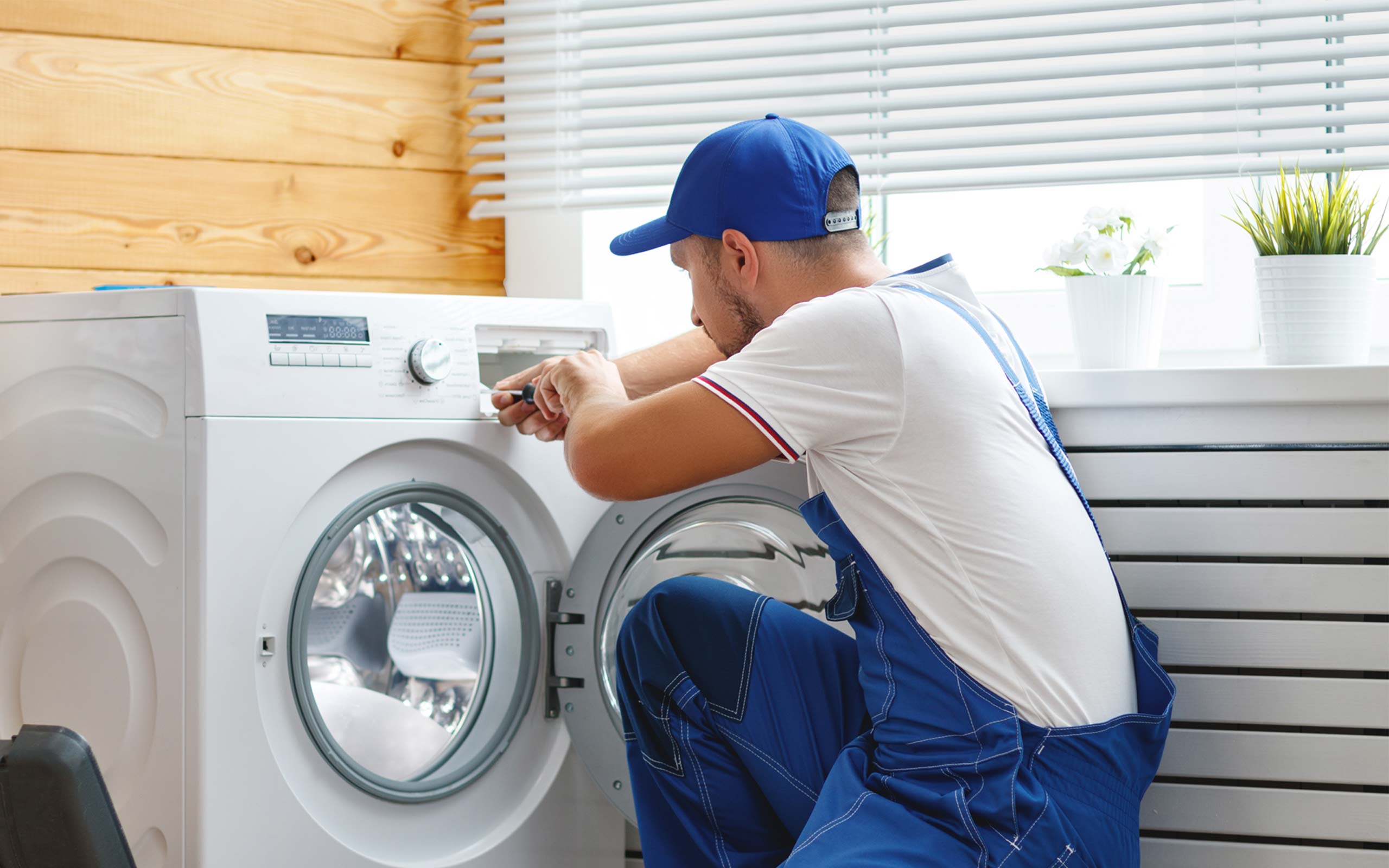 Technician repairing a washing machine