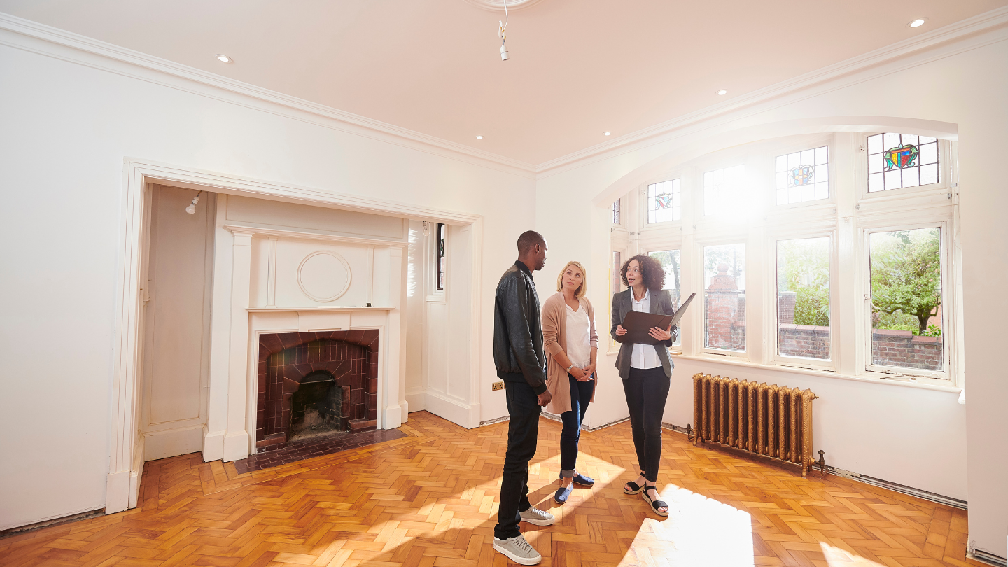 Owner walking tenants through an empty rental